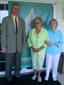 image:Delaware State Forester Michael A. Valenti joins Patricia Huff Stenger, center, and Jeanne Sposato after completing the purchase of 339 acres of forestland from the Sposato and Huff families