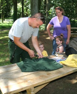 Jeffrey Wilson of Clayton preps his gear for the trip to Alaska as his young son Jeff, daughter Olivia, and wife Theresa look on.