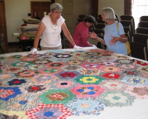 Volunteers cataloging a quilt at an earlier Quilt Harvest Day.