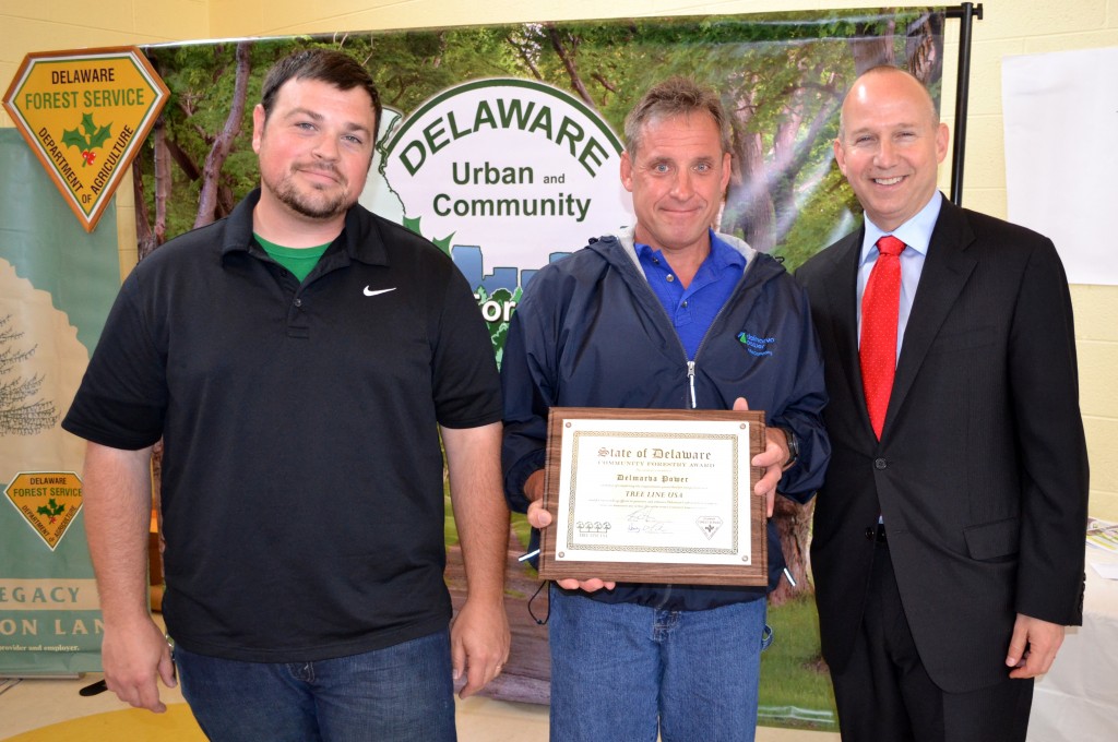 From left, Michael Krzyzanowski, Delmarva Power's Vegetation Management for its  New Castle Region, and Michael Casmay, Staff Forester, receive the Tree Line USA Award from Governor Markell.  