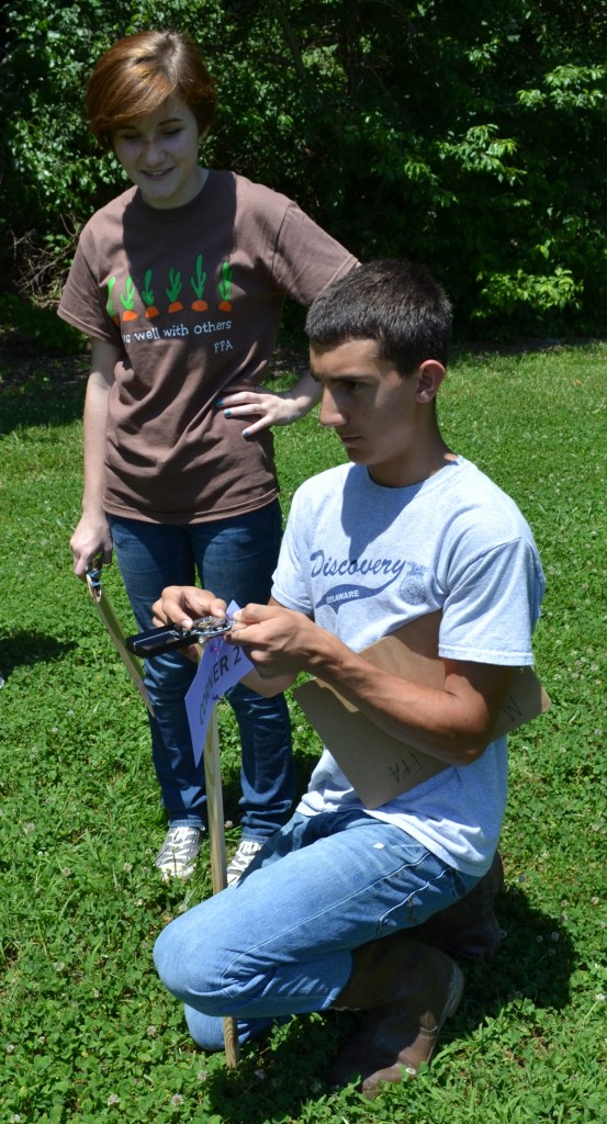 From left, Middletown H.S. FFA students Erin Fogarty and Will Nylander complete the compass-and-pacing section of the annual forestry challenge.
