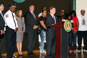 DE Attorney General Matt Denn announces indictments against members of a Wilmington street gang, while surrounded by law enforcement, Department of Justice prosecutors, and family members of murder victims.
