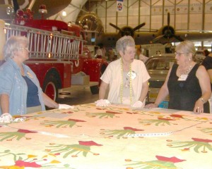 Volunteers cataloging a quilt at an earlier Quilt Documentation Day.