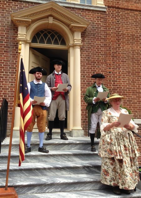 Old State House historical interpreters, dressed in period clothing, reciting the Declaration of Independence.