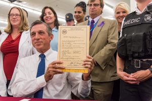 Governor Carney signs legislation making Nalaxone available in pharmacies. (Photo courtesy of Doug Curran/CVS Health)