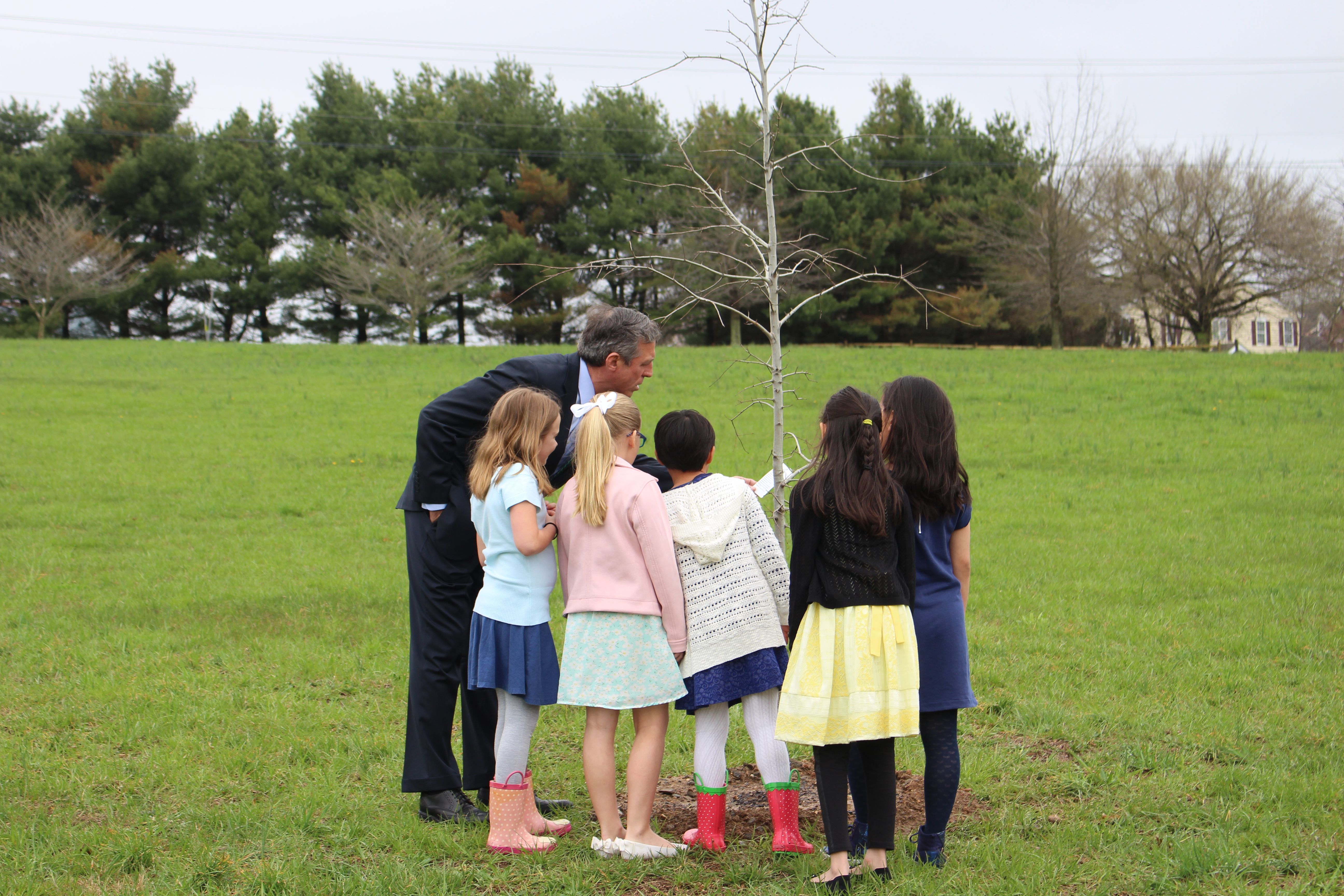 Governor Carney looks at a tree planted by students at North Star Elementary