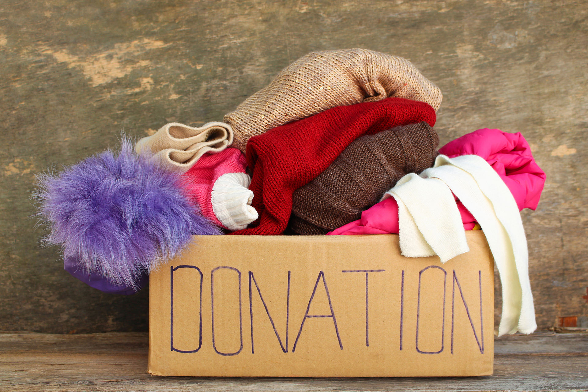 Image of a donation box with cold weather clothing inside