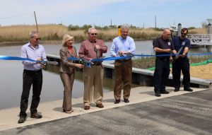 Cutting the ribbon at DNREC’s new boat ramp in Little Creek are, left to right: Little Creek Mayor Glenn Gauvry, Lt. Governor Bethany Hall-Long, State Representative William J. Carson Jr., DNREC Secretary Shawn M. Garvin, Little Creek Volunteer Fire Company Chief Michael Scott Bundek, and Little Creek Volunteer Fire Company President Kenneth Frazier. DNREC photo by Joanna Wilson.