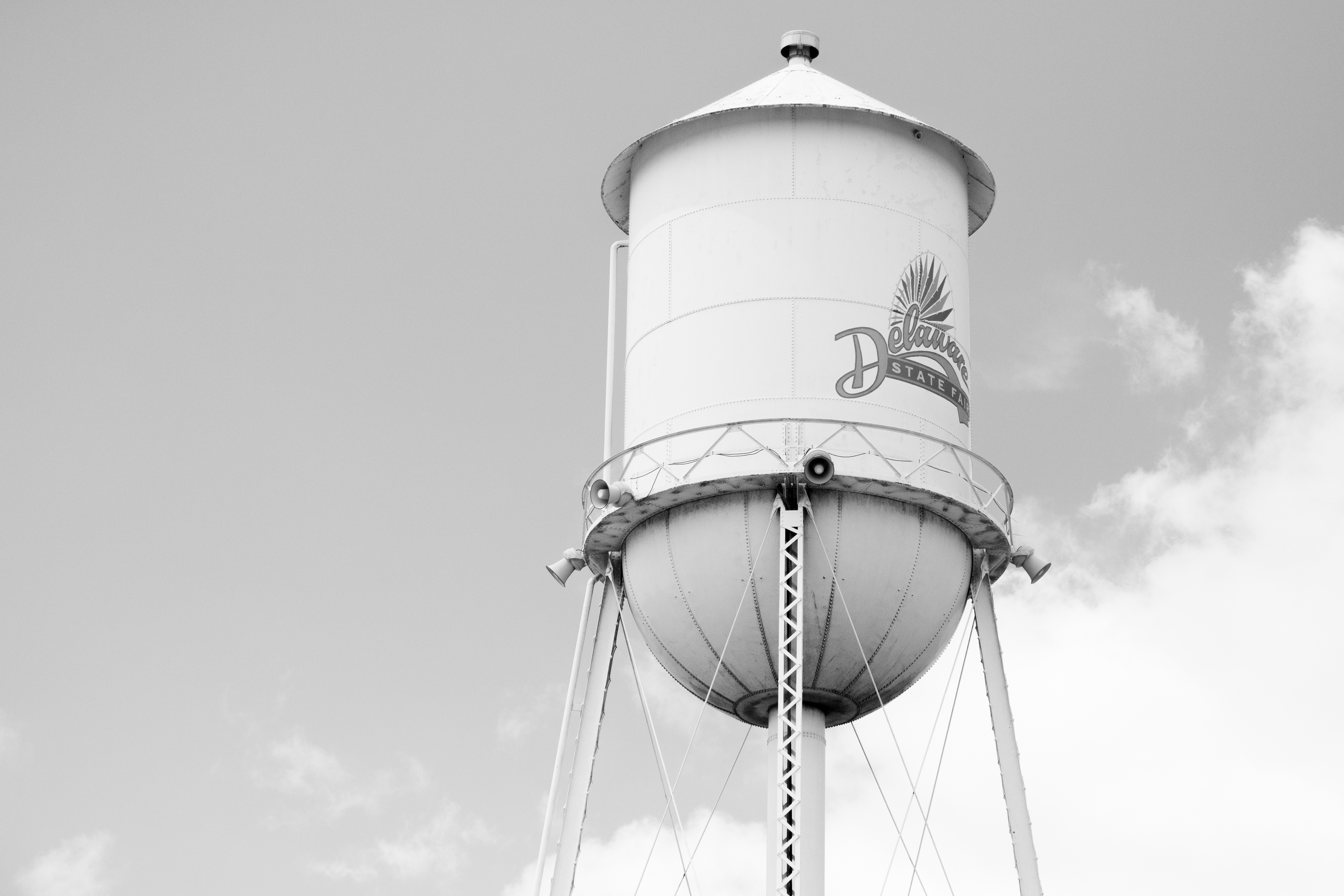 A black and white photo of the watertower in Harrington with the Delaware State Fair logo