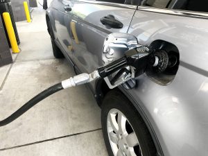 car with gas nozzle in tank