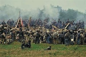 Photo of re-enactors portraying the fighting at the Sunken Road during the Battle of Antietam.