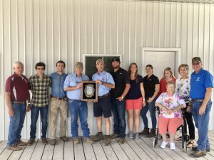 Group photo of Secretary Scuse presenting the Delaware Secretary's Award for Agriculture to the Vincent Family. Pictured Left to Right, Delaware Secretary of Agriculture Michael T. Scuse, along with the Vincent Family: Josh, Nathaniel, Ray, Clay, Jonah, Erin, Haley, Connor, Carole (seated), Teresa, Deputy Secretary of Agriculture Kenny Bounds.