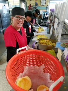 School nutrition worker prepares meals with fresh sqaush