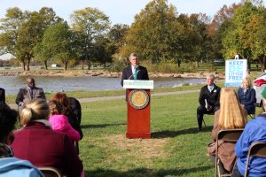 Governor Carney stands outdoors behind a podium to announce Delaware's Climate Action Plan