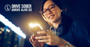 Woman using cell phone to plan sober ride