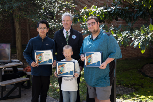 Delaware Department of Natural Resources and Environmental Control Secretary Shawn M. Garvin, center, with the winners of DNREC’s 2022 Earth Day Video Contest, left to right: Middle school winner Johannes Chow, Elementary school winner Michael Hopkins and High school winner Nathen Going. DNREC Photo.