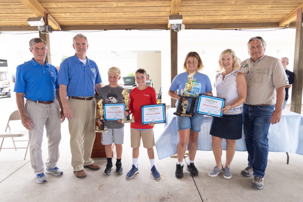 DNREC Secretary Shawn M. Garvin and Governor John Carney with the 2022 Youth Fishing Tournament winners: Sussex County winner Brody Spencer, Kent County winner Dominic Webb, New Castle County and statewide winner Onna Crowley; Lt. Governor Bethany Hall-Long; and DNREC Division of Fish and Wildlife Director Dave Saveikis. DNREC photo.