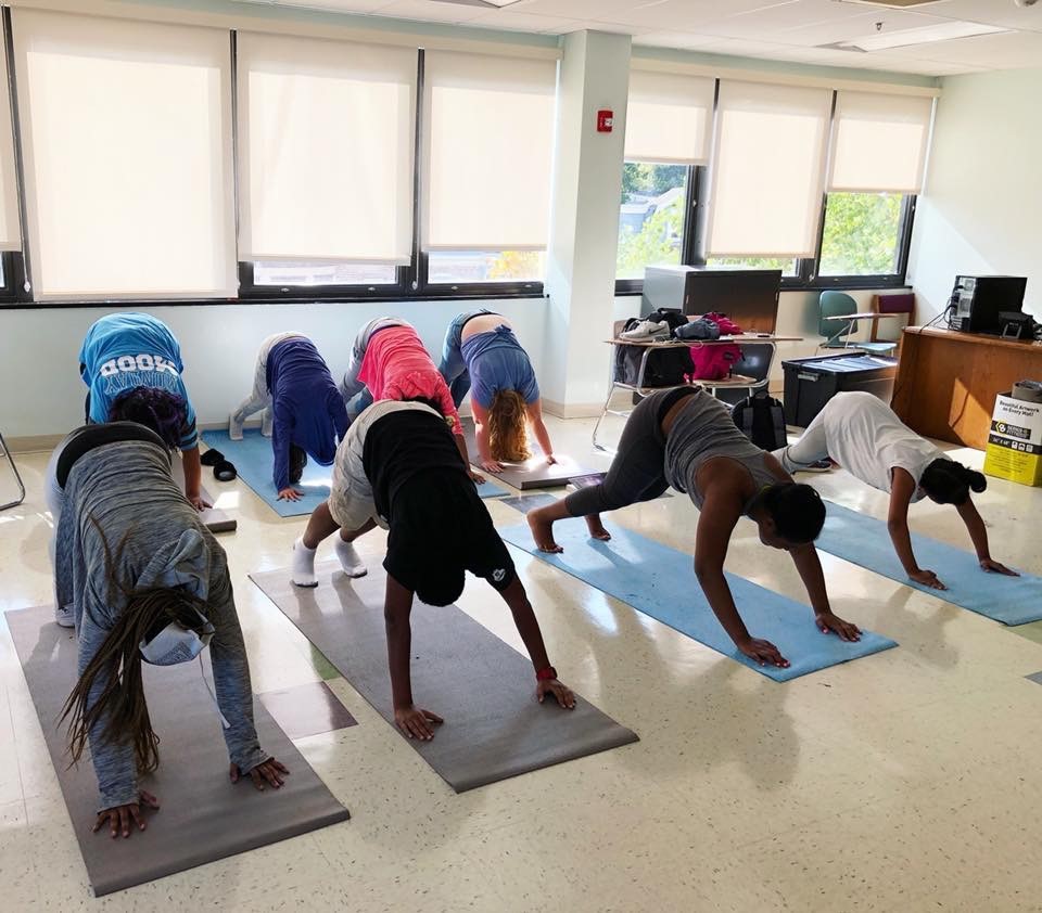 Students in a class doing yoga.
