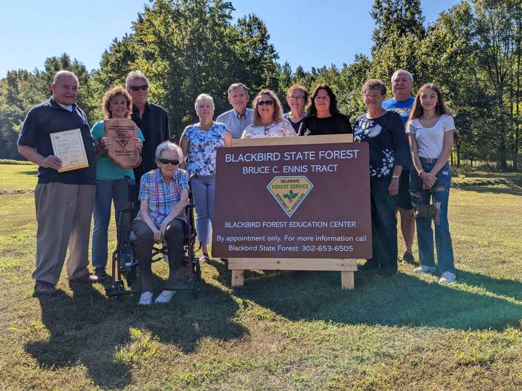 Senator Ennis with his family at Blackbird State Forest around the new Ennis Tract sign