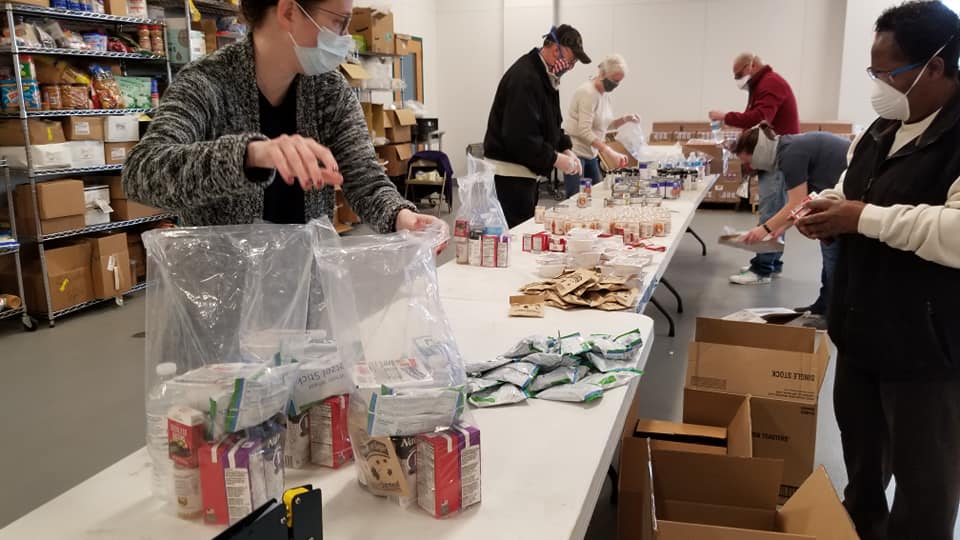 Volunteers filling food kits at the Food Bank