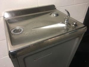 This image shows a drinking water fountain typically found in a school hallway.