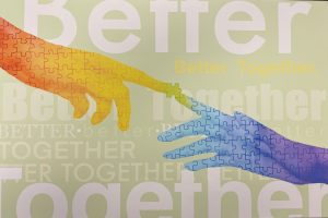 Poster of two colorful hands touching