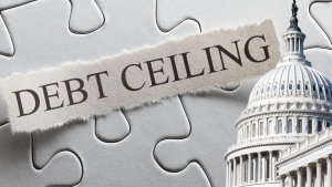 Words debt ceiling over jigsaw puzzle pieces with a picture of the U.S. Capital
