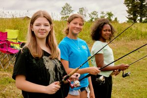 Photo of Delaware Youth Fishing Tournament participants holding fishing rods.