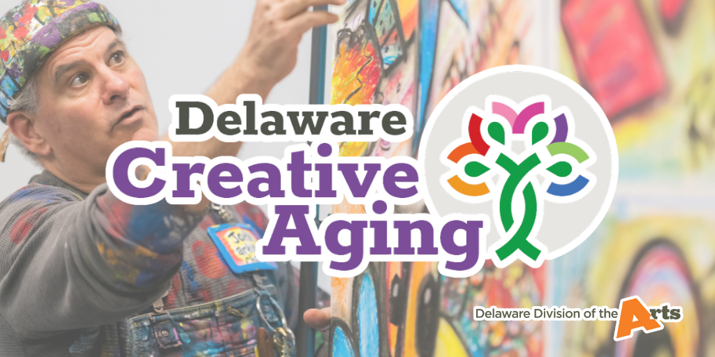 An artist pointing to colorful artwork with the Delaware Creative Aging logo overtop