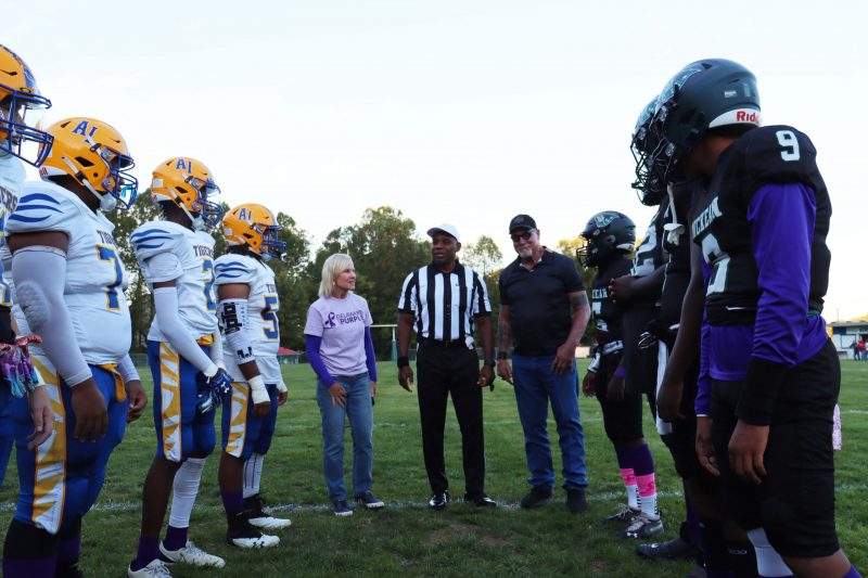 NFL Hall of Famer Randy White and Lt. Governor Bethany Hall-Long participate in the coin toss at the Thomas McKean and A.I du Pont football game on Friday, October 13 during the kick off for the Coaches vs. Overdoses initiative to curb opioid abuse.