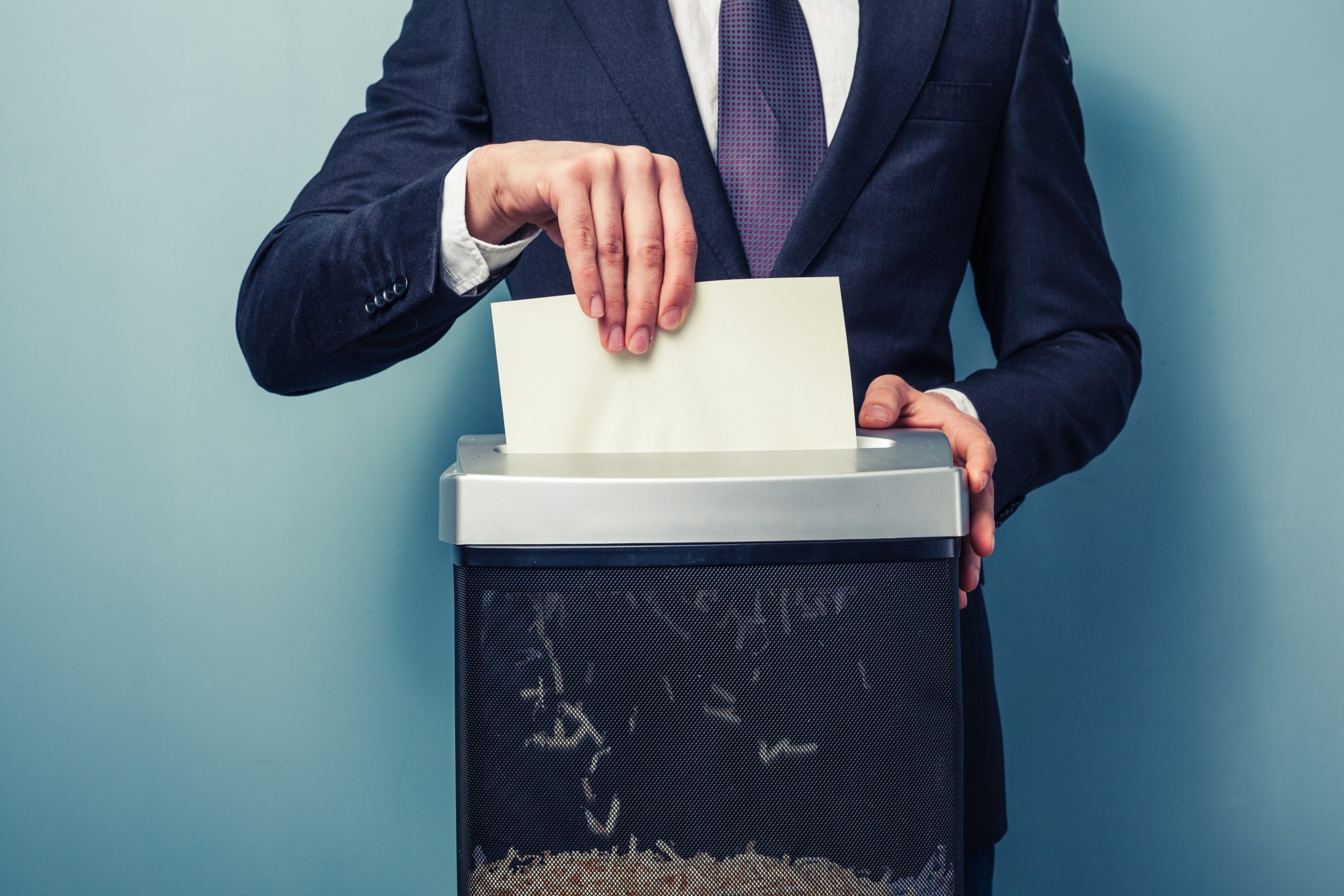 A Businessman is shredding inaccurate documents