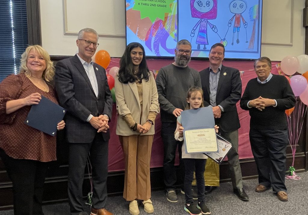 Naomi Feely, the 1st place winner of the K through 2nd grade category, is pictured alongside her father, GACEC Executive Director, Pam Weir, Representative Yearick, Khazra Fatima, Senator Paradee and Mayor Christiansen.