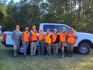 Instructors and participants in hunting gear