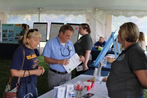 Visitors learn about electric vehicle rebates at Coast Day.