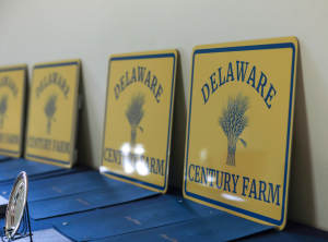 The new Delaware Century Farm signs on display, along with tributes and an engraved pewter plate to be presented to a farm family receiving this designation.