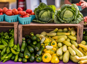 Tomatoes, cabbage, and squash at a farmers market booth in Delaware