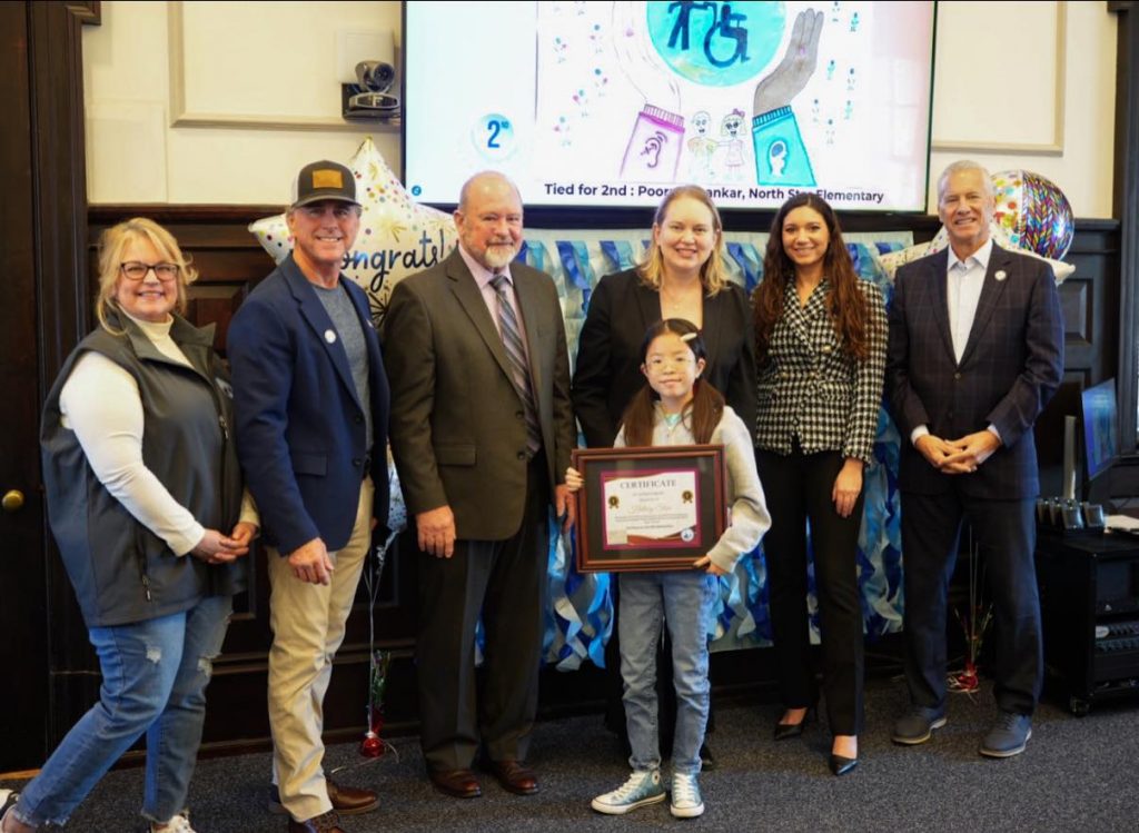 Pictured (left to right) are GACEC Executive Director Pam Weir, Senator Eric Buckson, Senator Dave Lawson, Representative Melanie Levin, Representative Sophie Phillips, Representative Lyndon Yearick, and Hilary Shen (front center), a 5th grader at North Star Elementary and 1st place winner in the 3rd to 5th grade category.