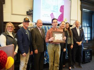 Pictured (left to right) are GACEC Executive Director Pam Weir, Senator Eric Buckson, Senator Dave Lawson, Representative Melanie Levin, Representative Sophie Phillips, Representative Lyndon Yearick, and Clark Kummer (front center), a senior at Concord High School and 1st place winner in the Adapted Art category.