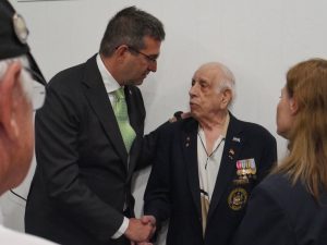 Governor Meyer shakes hands with a veteran.