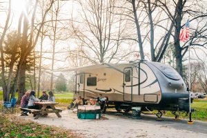 A family enjoys fall camping in their RV at Lums Pond State Park, one of five camping locations in Delaware State Parks.