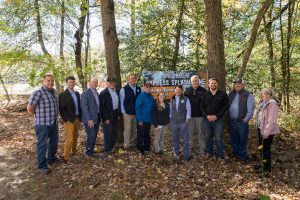 Members of the Delaware General Assembly, Sussex County Council, Delmarva Veteran Builders, GWWO and DNREC Secretary Gregory Patterson and the Division of Parks and Recreation celebrate the start of the Cypress Splash Zone at Trap Pond State Park in front of a banner announcing its debut in mid-summer 2026.