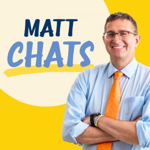 Governor Matt Meyer stands off-right wearing a light blue button down shirt and an orange tie in front of a yellow background. In the upper left in a light yellow bubble says Matt Chats in a fun blue font.