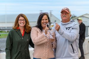 Winners of the DSBF Tuesday filly race, smiling and holding the trophy, presented by Senator Kyra Hoffner.
