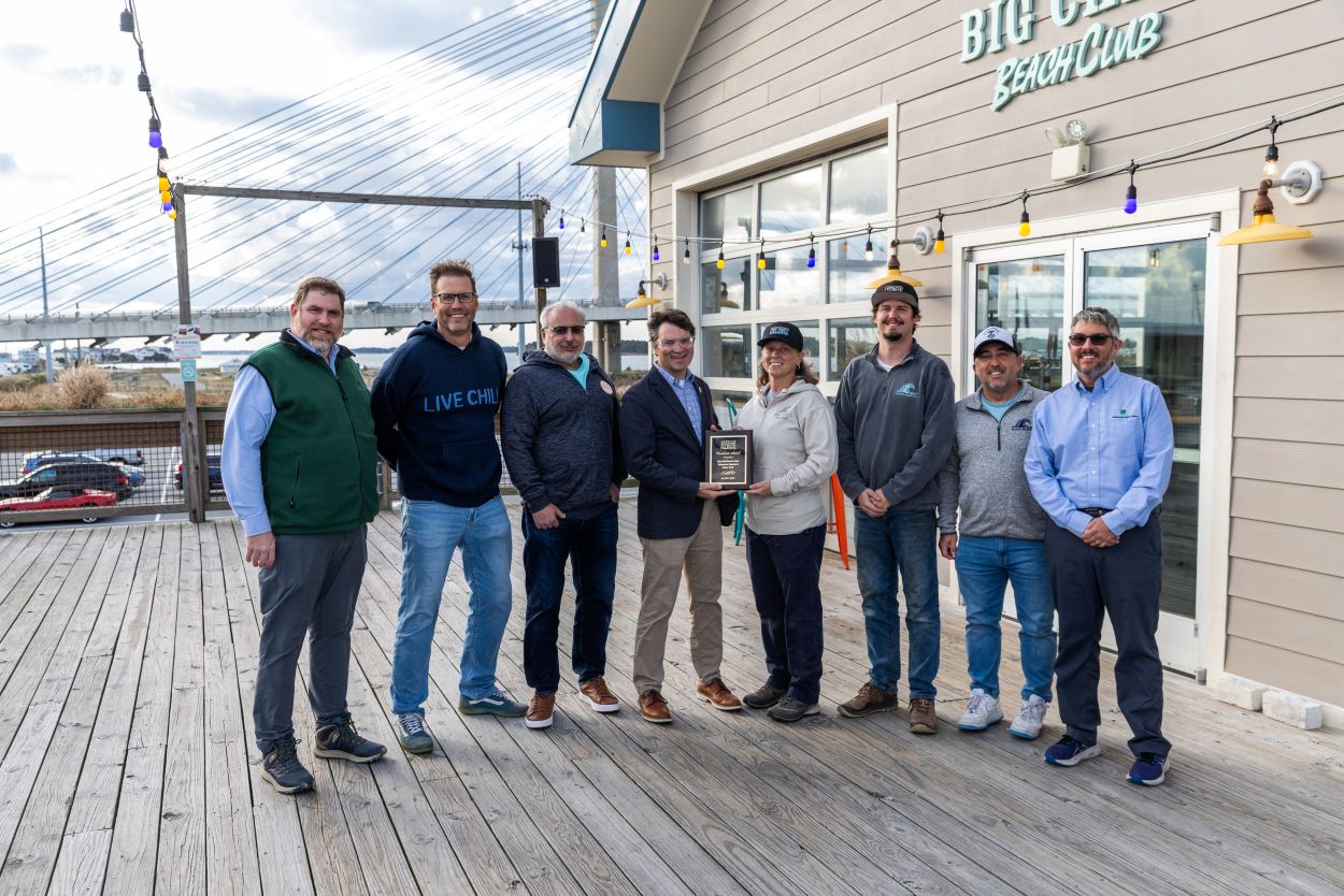 Leaders from DNREC and the Division of Parks and Recreation present an award from the National Association of State Park Directors Big Chill Beach Club in recognition of their contributions to Delaware State Parks and the community. Pictured l to r are Brooks Cahall (Parks Environmental Program Administrator), Big Chill Owners Joseh Grapski and Mitch Rosenfeld, DNREC Secretary Greg Patterson, Big Chill Manager Becca Anderson, Matt Garbutt and Rich Garrahan of La Vita Hospitality and Park Superintendent Scott Borino.