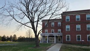 A three story building with the words DHSS over the entrance doors..