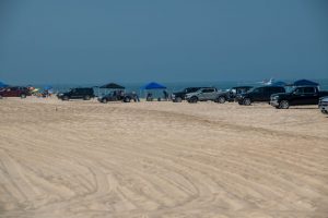 Trucks and sport utility vehicles line up at 3 R's at Delaware Seashore State Park, one of five drive-on beaches that require reservations on weekends and holidays in summer.