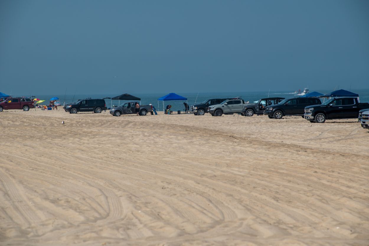 Trucks and sport utility vehicles line up at 3 R's at Delaware Seashore State Park, one of five drive-on beaches that require reservations on weekends and holidays in summer.