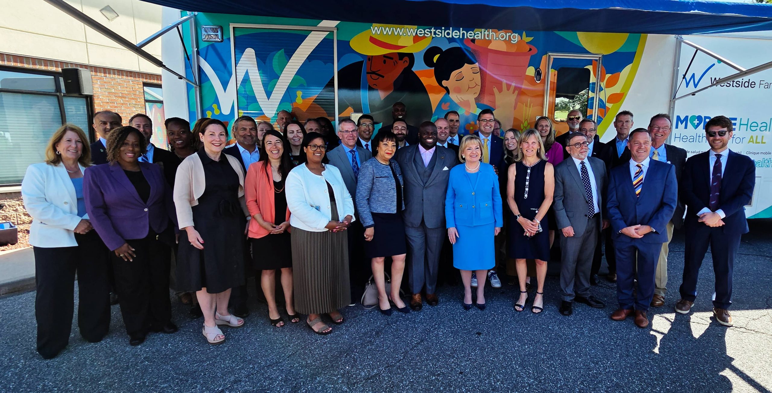 Attendees of the announcement of the new Delaware Medical School take a group photo at Westside Health in Dover