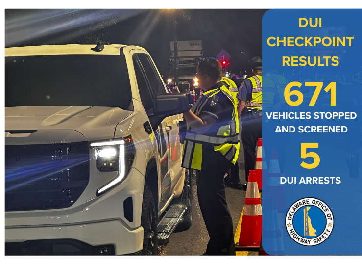Officers standing at the side of the vehicle during a DUI checkpoint