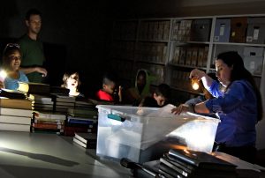 guests take part in flashlight tour during night at the archives